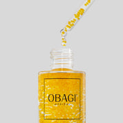 Obagi skincare serum bottle with dropper being used