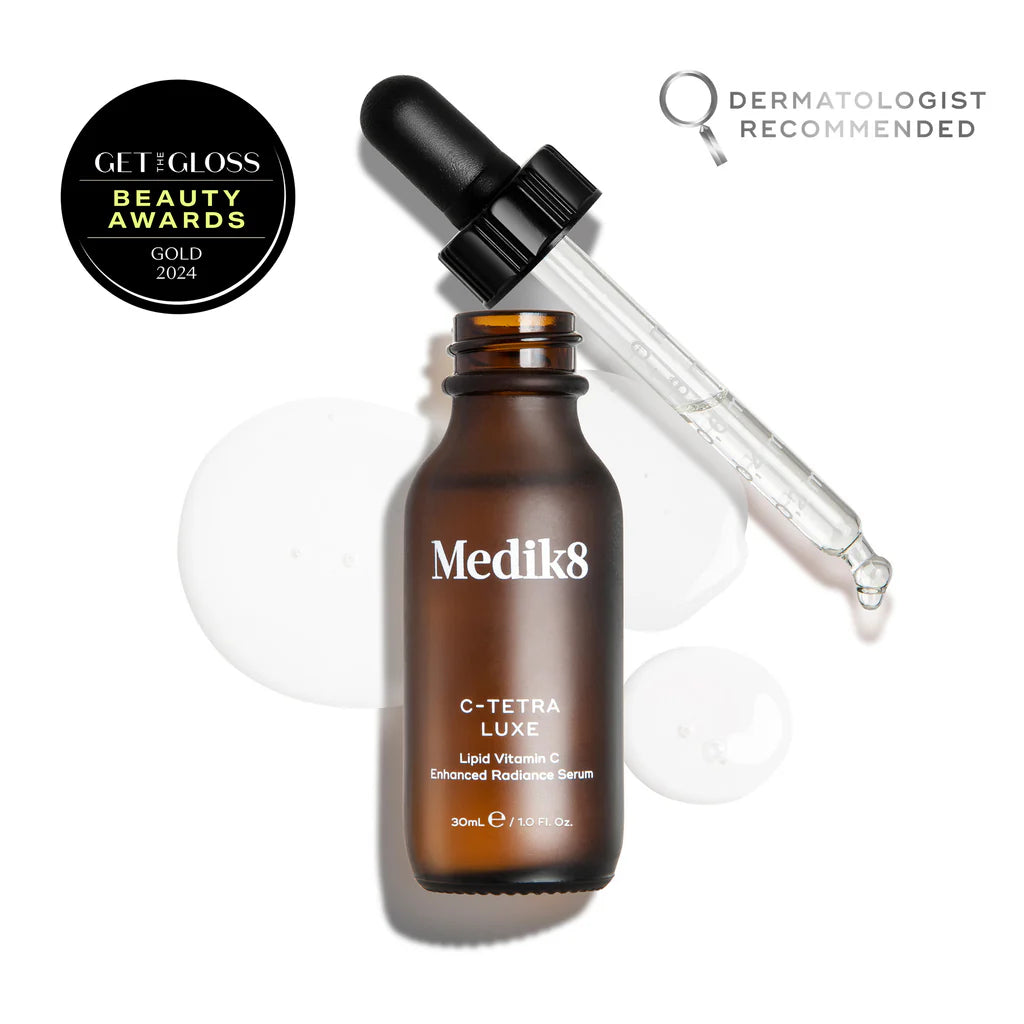Medik8 C-Tetra Luxe serum bottle with dropper on a white background, featuring Get Gloss Beauty Awards and Dermatologist Recommended badges.