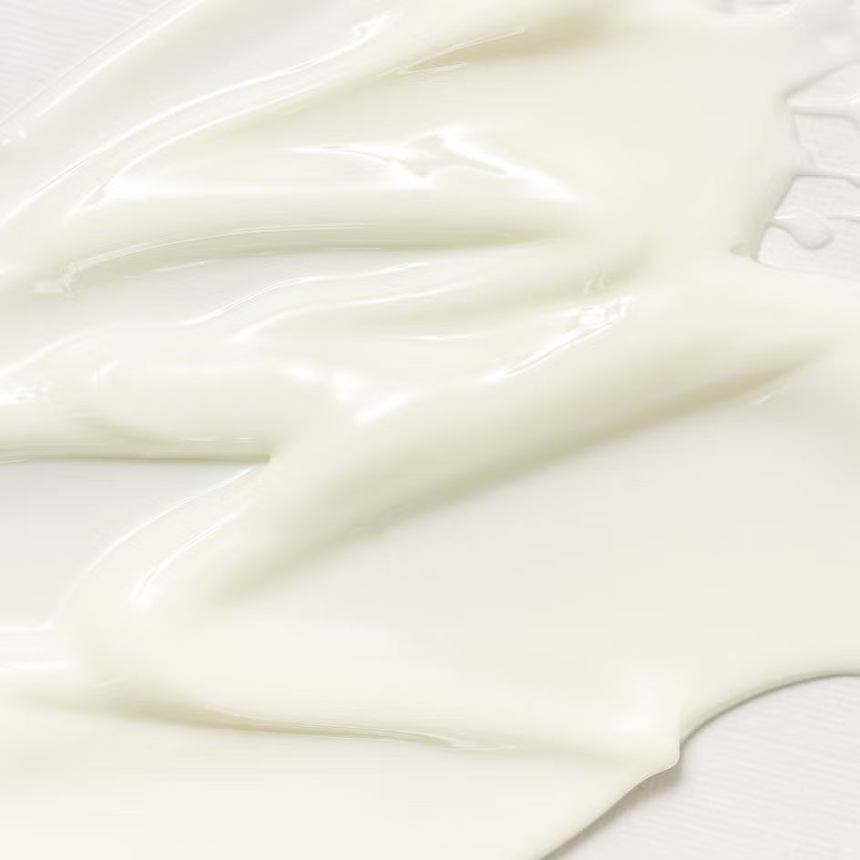 Close-up of smooth, white cream on a light background