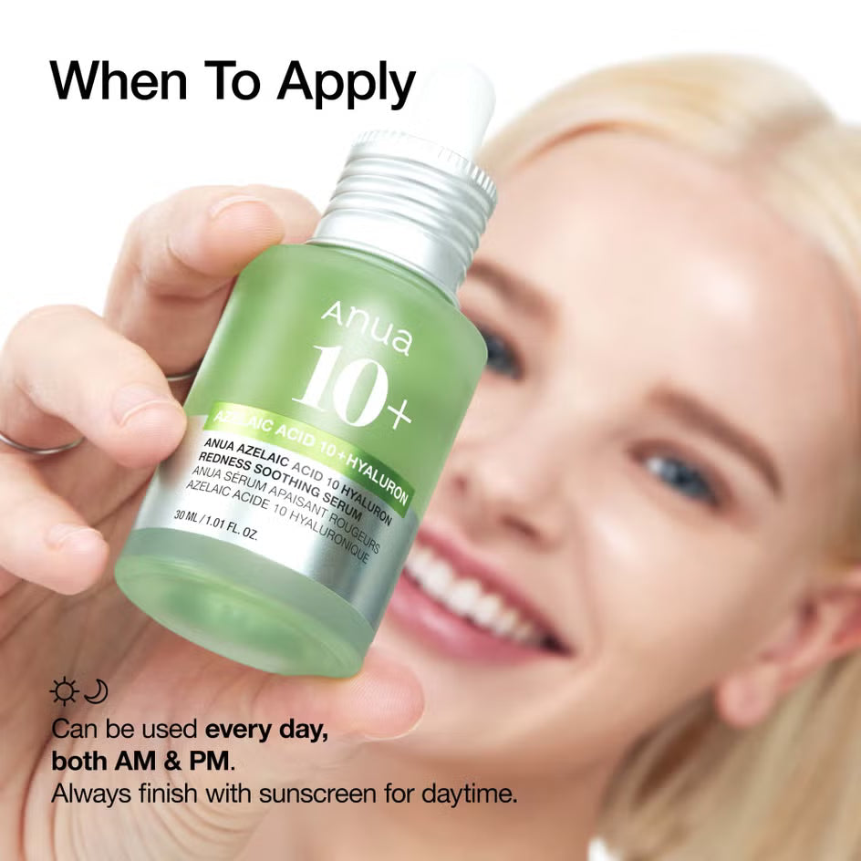Hand holding a green skincare bottle with text about application times, against a blurred background of a smiling person.