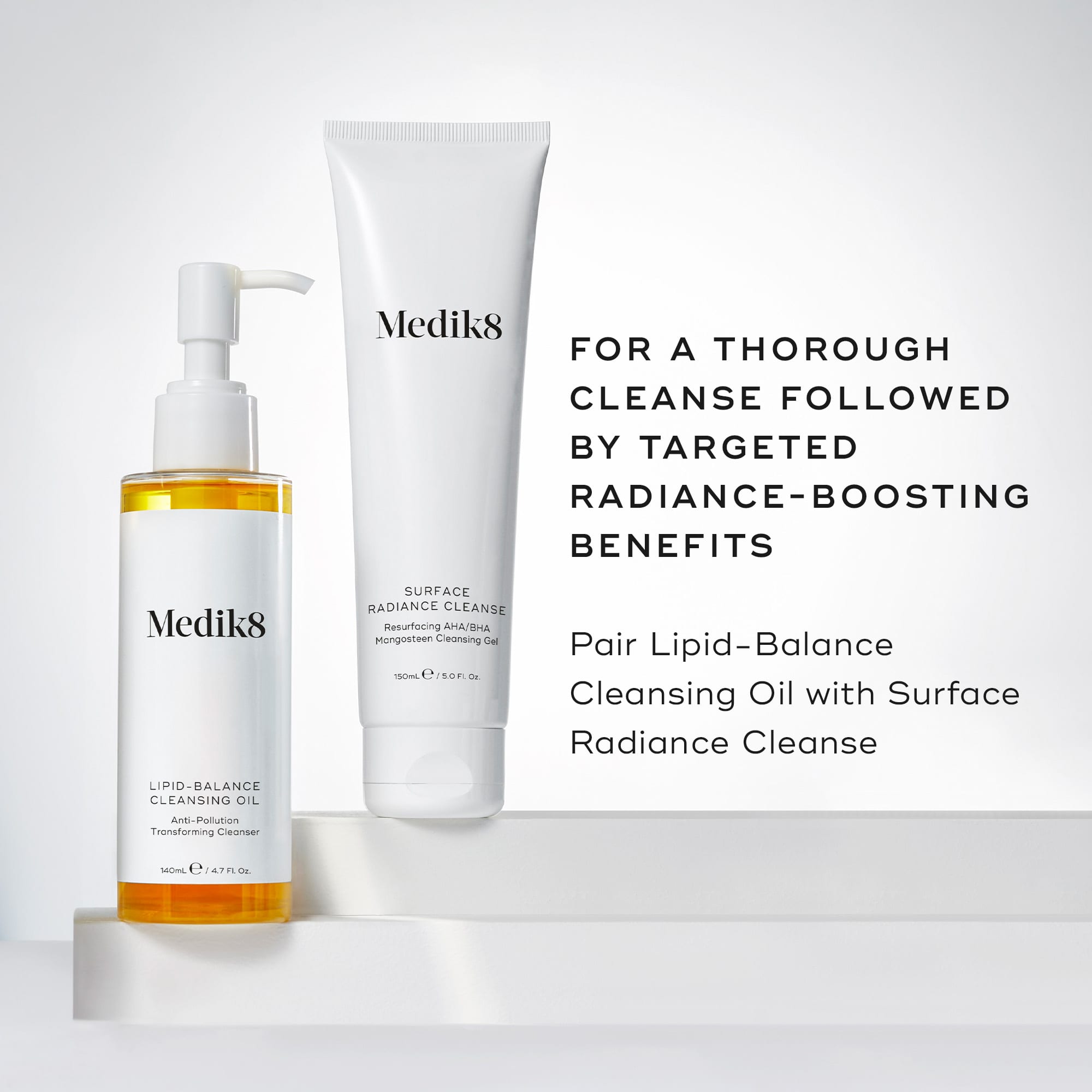 A pump bottle of Medik8 Lipid-Balance Cleansing Oil against a white background, alongside a tube of Medik8 Surface Radiance Cleanse 