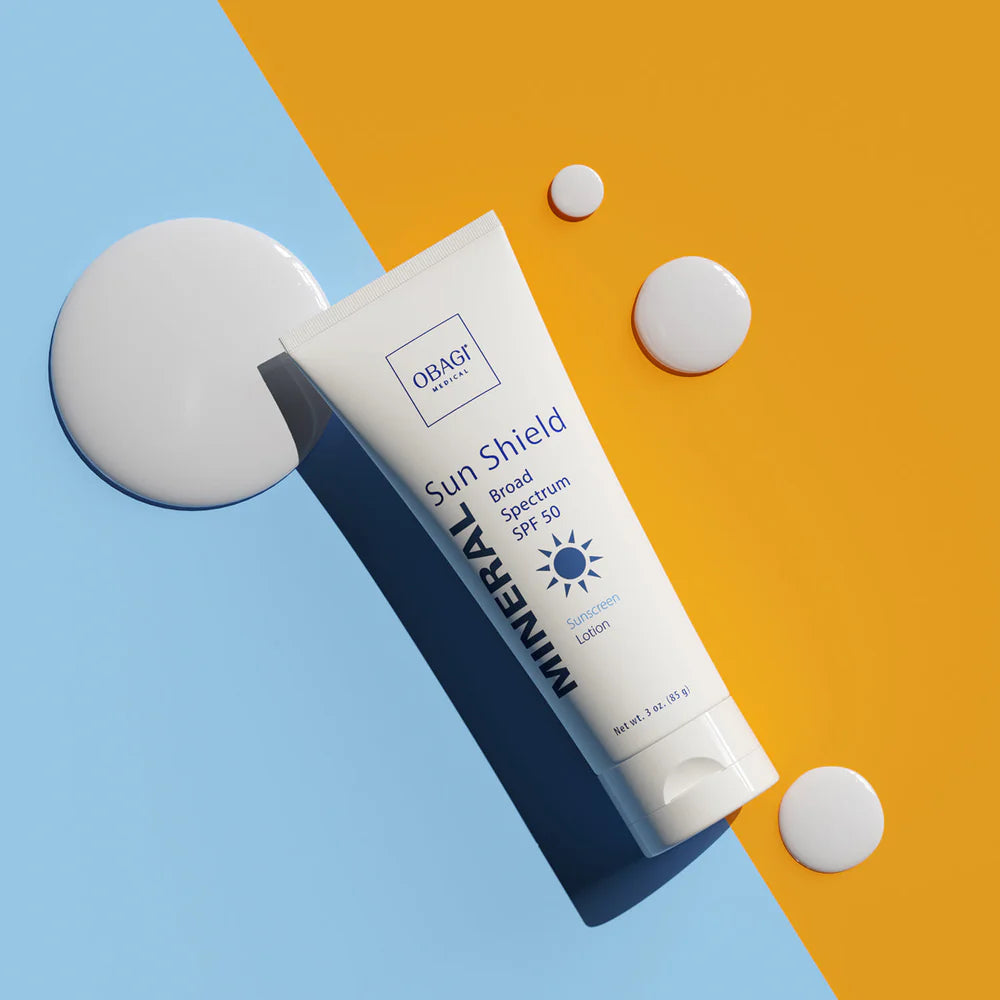 OBAQ Sun Shield sunscreen tube on a two-tone background
