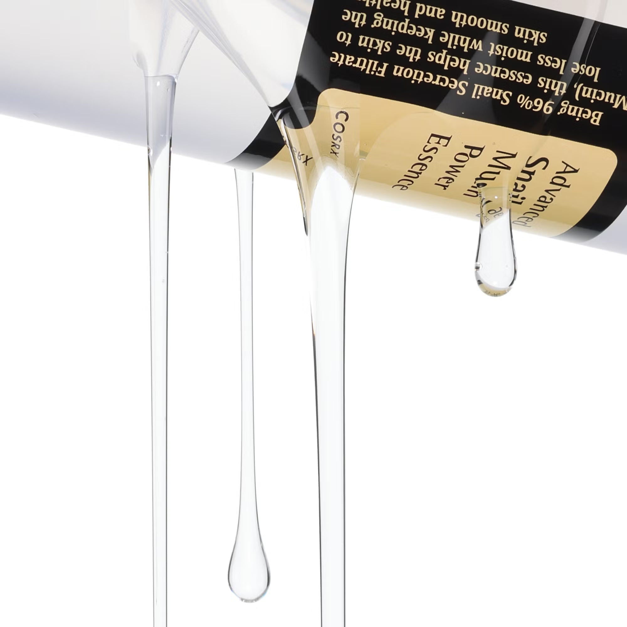 Cosmetic bottle with droplets of product on a white background