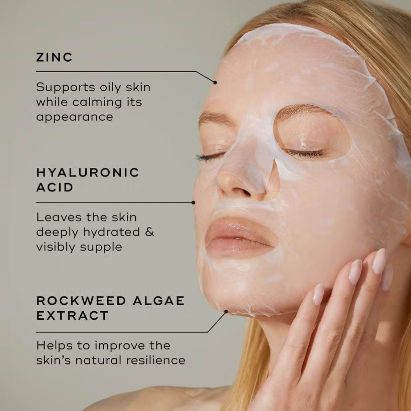 Woman using Medik8 Ultimate Recovery Bio-Cellulose Mask with key ingredients listed 