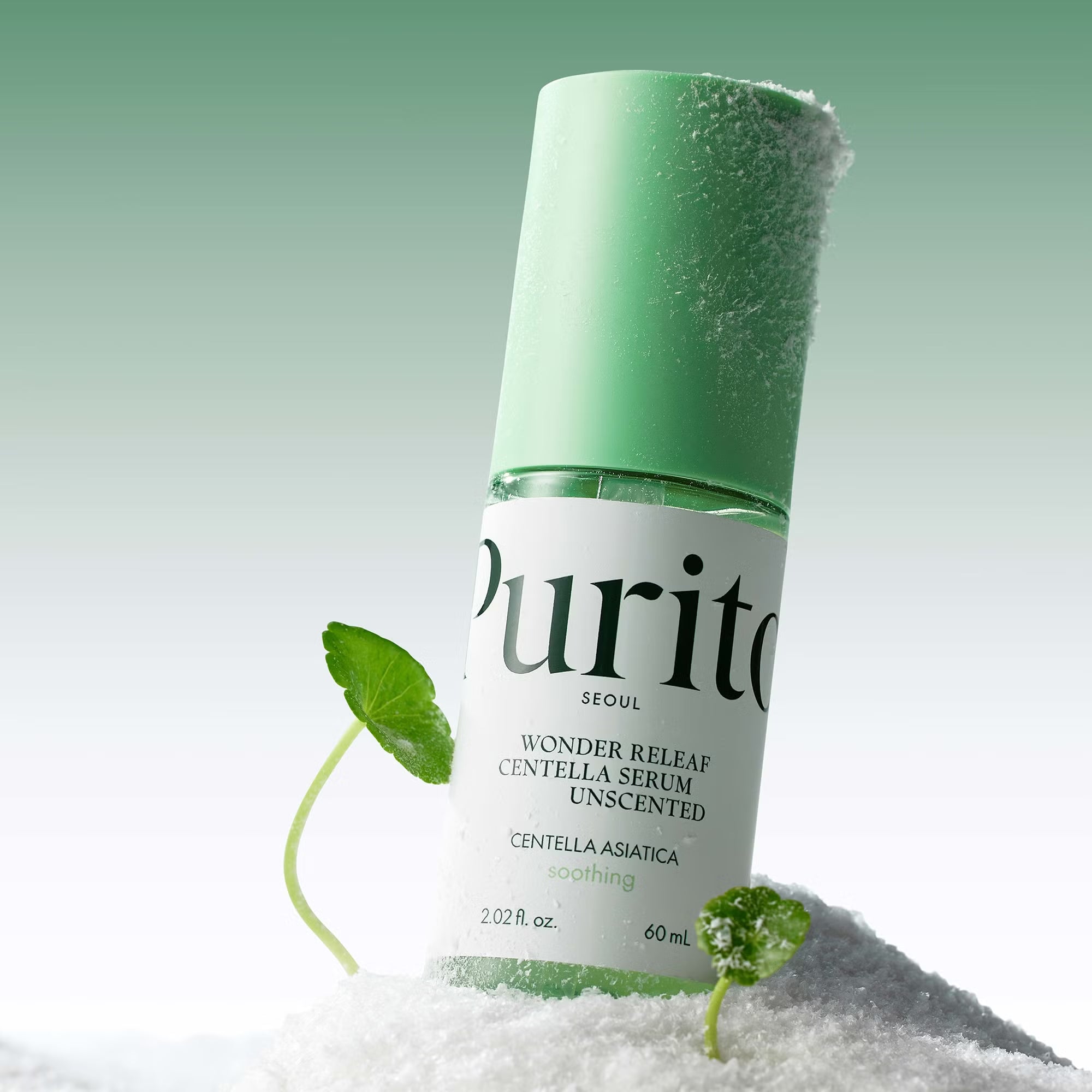 Purito skincare serum bottle with green cap and leaves on a white background